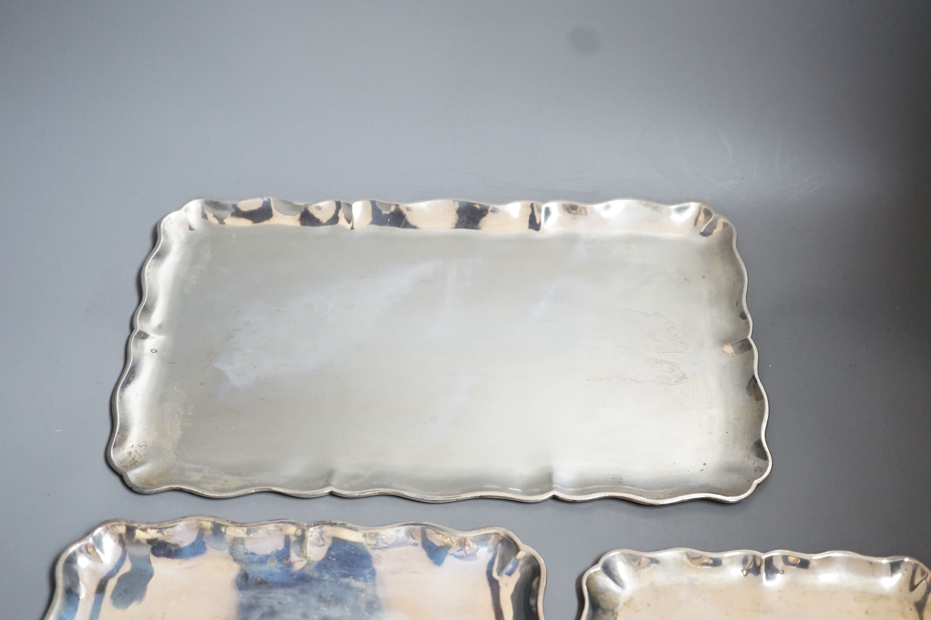 A graduated suite of three Austro-Hungarian white metal trays with wavy borders, largest 34.5cm, 36oz.